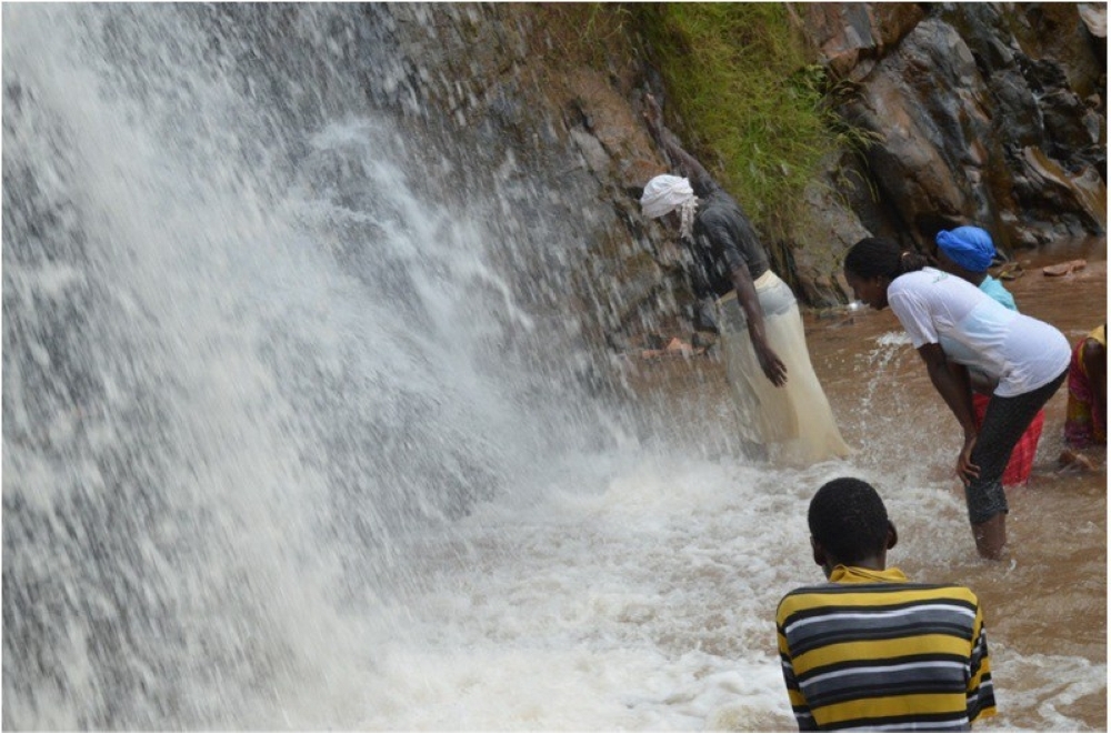 Christians seek healing at a waterfall in Nyungwe National Park. Rwanda has closed over 10000 churches that are not meeting minimum standards required by Rwanda Governance Board. Courtesy