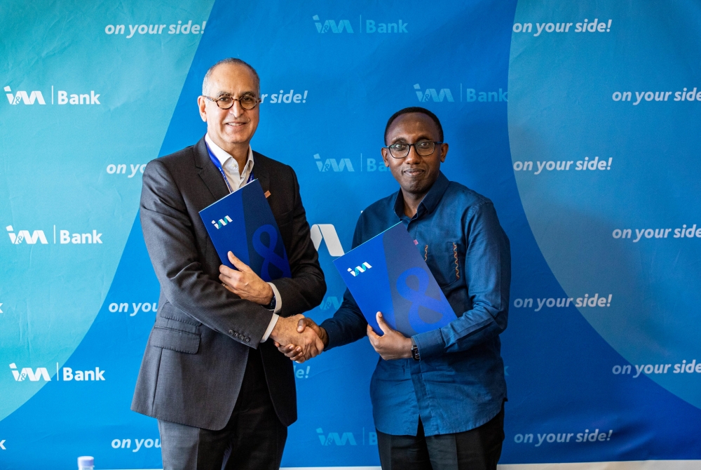 I&M Bank (Rwanda) Plc, CEO  Benjamin Mutimura (L) and  Jetu Lalvani, CEO of Kaizenvest during the signing ceremony on Friday, November 29. All photos by Dan Gatsinzi