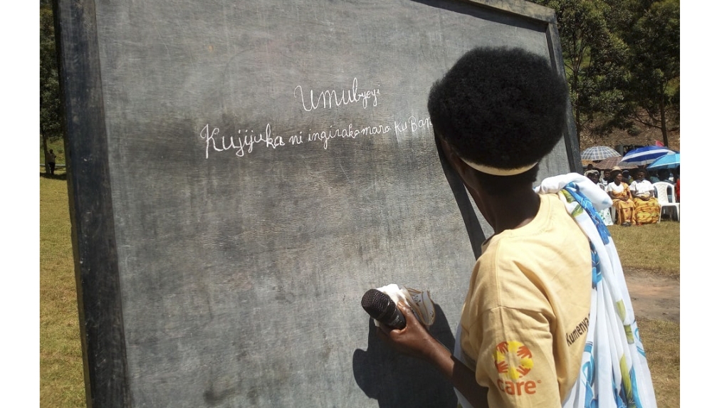 Venantie Mukamutara, one of the residents who completed literacy training for adults, showcases her writing skills during a graduation ceremony in Gisagara District in August 2024. Courtesy