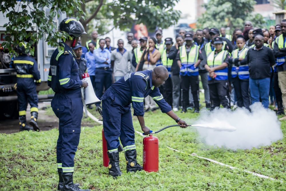 I&M Bank employees, customers, and nine tenants follow instructions on how to deal with fire outbreak during drills at the bank headquarters on Friday, December 7. All photos by   Emmanuel Dushimimana