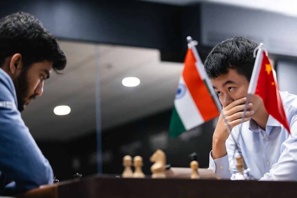 Defending world champion GM Ding Liren (right) eyes his challenger, Indian star GM Gukesh Dommaraju (left), during Game 14 of the 2024 FIDE World Championship match at Singapore&#039;s Equarius Hotel in Resorts World Sentosa, on Thursday, December 12. Courtesy of FIDE