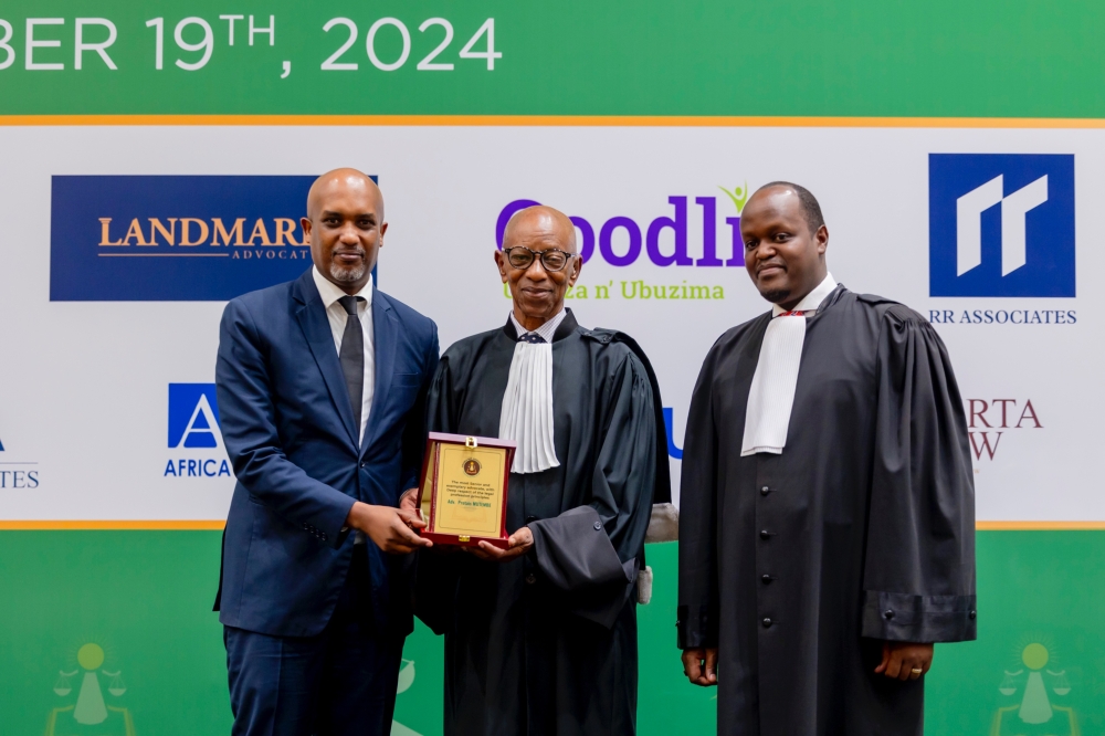Justice Minister Emmanuel Ugirashebuja (left), and the President of Rwanda Bar Association, Moise Nkundabarashi (right) recognise Adv. Protais Mutembe (centre), for his outstanding contributions to the legal profession. COURTESY