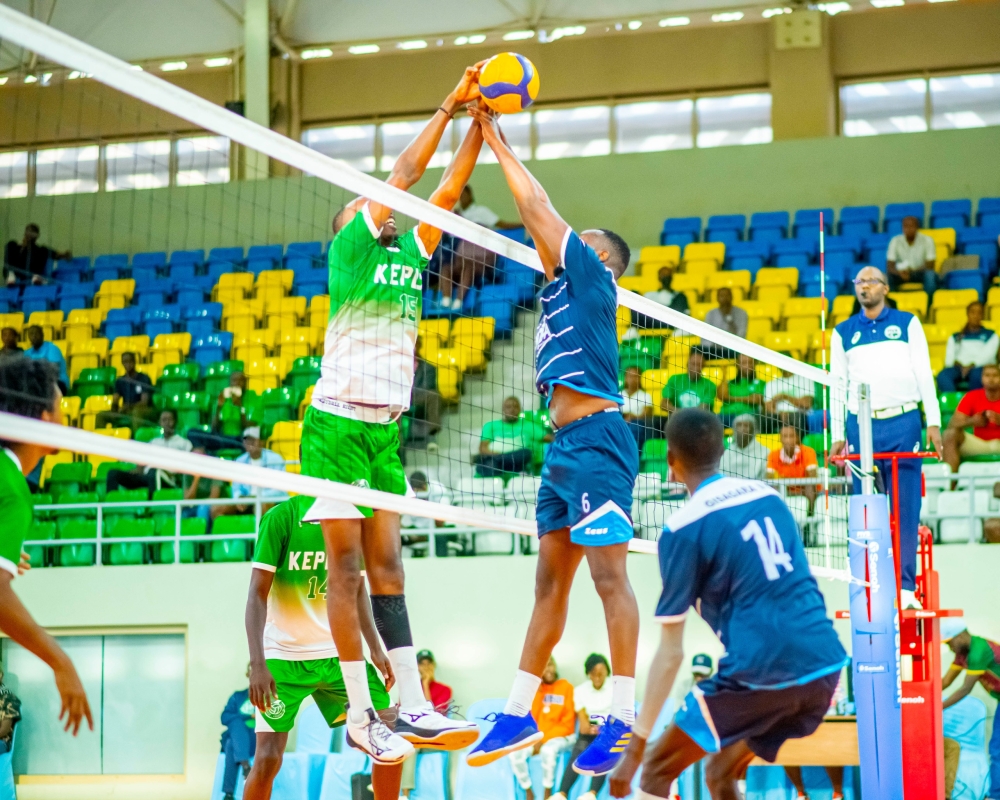 A Kepler player (L) engages in an aerial duel with his Police counterpart during the game.