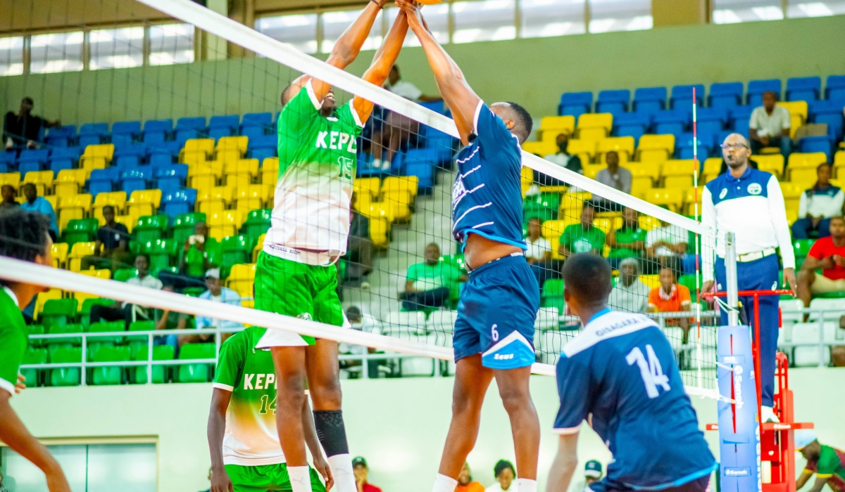 A Kepler player (L) engages in an aerial duel with his Police counterpart during the game.