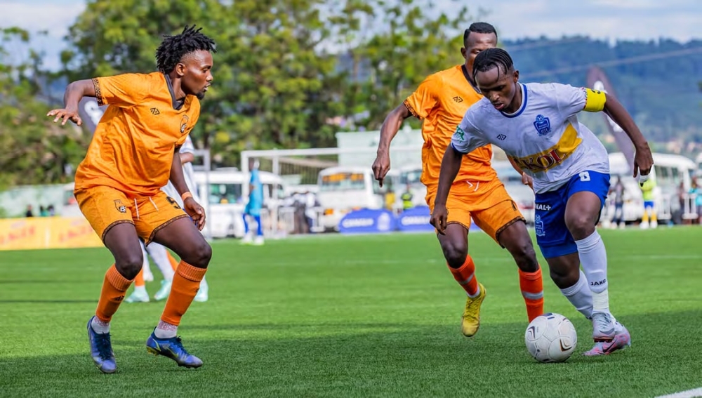 Rayon Sports captain Kevin Muhire tries to go past Bugesera FC defenders during a Peace Cup game. Photo: Emmanuel Dushimimana