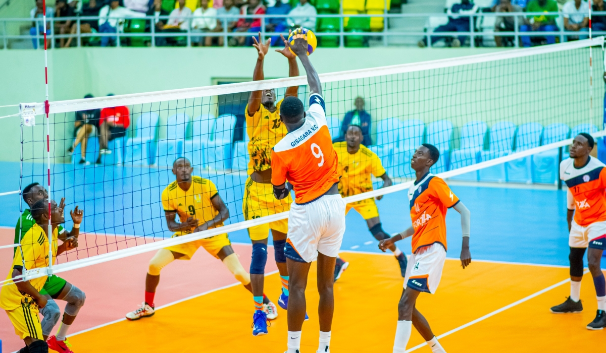 A Gisagara VC player (L) launches a spike as his EAUR attempts to defend.