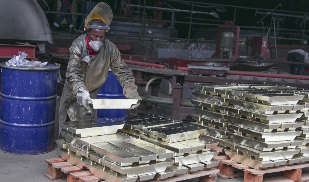 A worker arranges some melted tin for export in Kigali. Sam Ngendahimana
