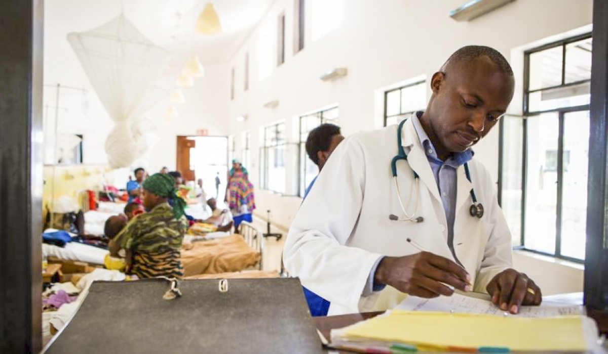 Dr. Cyprien Shyirambere, oncology program director for Partners In Health in Rwanda, records medical information after seeing patients for follow-up visits at PIH-supported Butaro District Hospital.