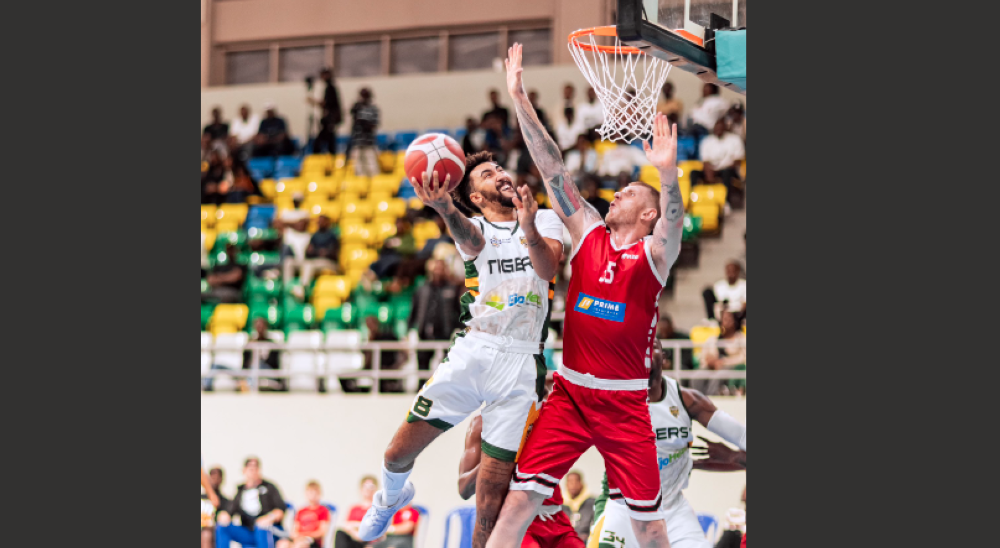 REG Center Pieter Prinsloo tries to block a Tigers opponent during a past game in the Rwanda Basketball League . The South African move to play in Rwanda despite interests from other clubs overseas-courtesy