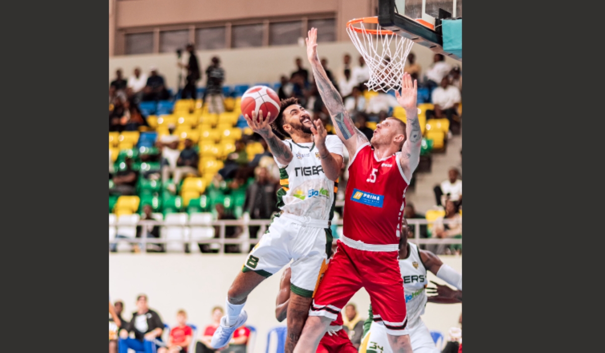 REG Center Pieter Prinsloo tries to block a Tigers opponent during a past game in the Rwanda Basketball League . The South African move to play in Rwanda despite interests from other clubs overseas-courtesy