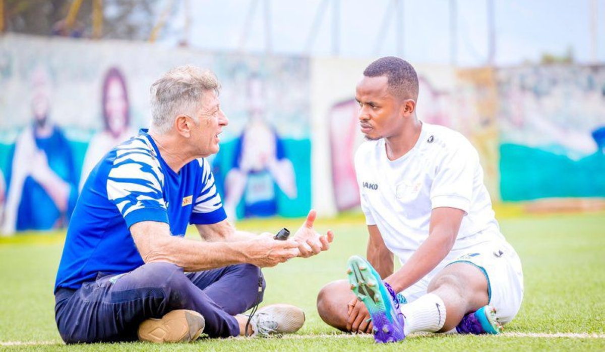 Muhire (R) chats with Rayon Sports coach Robertinho. The attacking midfielder has been one of the key players for the club this season.