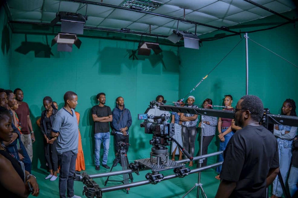 The Head of Department Mr Festus Irungu with students admiring the new equipment being set up in the TV studio.