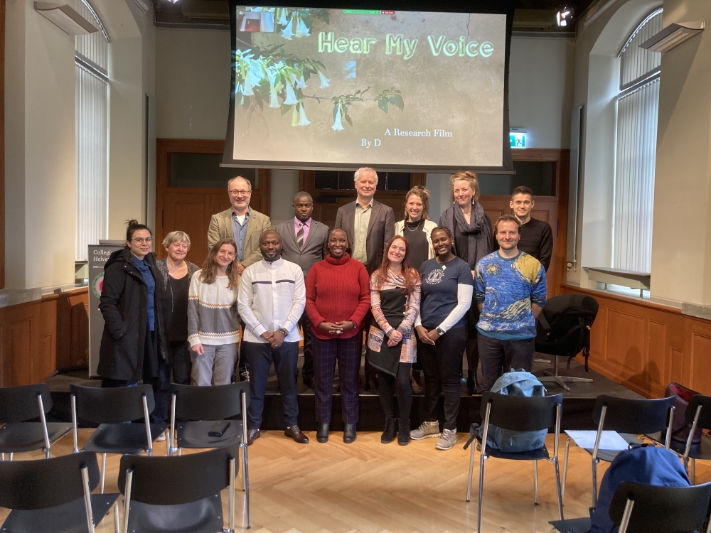 Rwandan clinical psychotherapist and filmmaker, Dr. Celestin Mutuyimana (dressed in white) posing for a group picture with some of the attendees at the film launch on February 26, in Switzerland