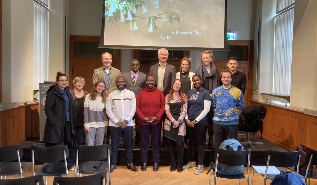 Rwandan clinical psychotherapist and filmmaker, Dr. Celestin Mutuyimana (dressed in white) posing for a group picture with some of the attendees at the film launch on February 26, in Switzerland