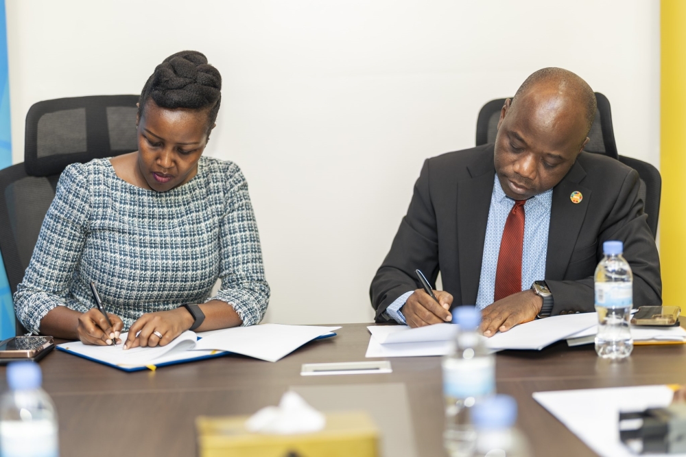 Paula Ingabire, Minister of ICT and Innovation and Dr Olugbemiga Adelakin, UNFPA Country Representative for Rwanda sign the agreement in Kigali