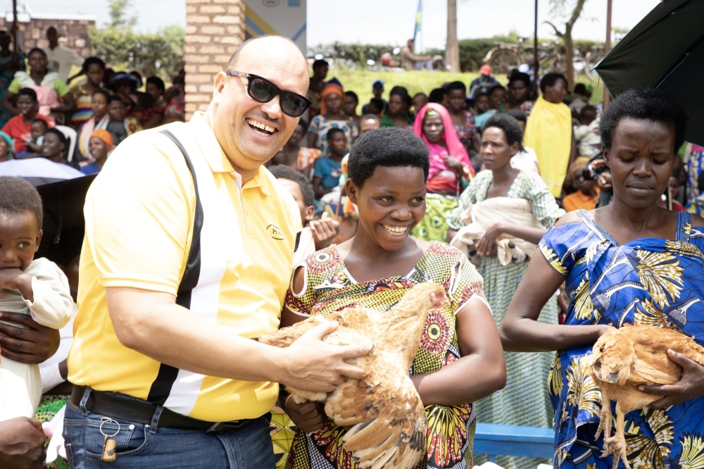 MTN Rwanda&#039;s Alain Numa hands over a laying chicken to a beneficiary. This initiative aims to eliminate malnutrition and address the issue of poor nutrition.
