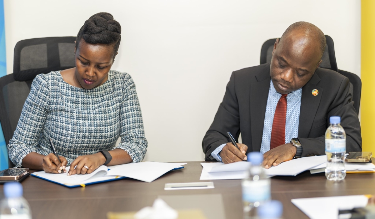 Paula Ingabire, Minister of ICT and Innovation and Dr Olugbemiga Adelakin, UNFPA Country Representative for Rwanda sign the agreement in Kigali