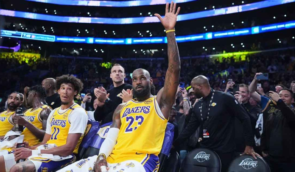 LeBron James waves to the crowd after making a 3-point basket to become the first player in NBA history with 50,000 combined points in the regular season and postseason. Jae C. Hong/AP
