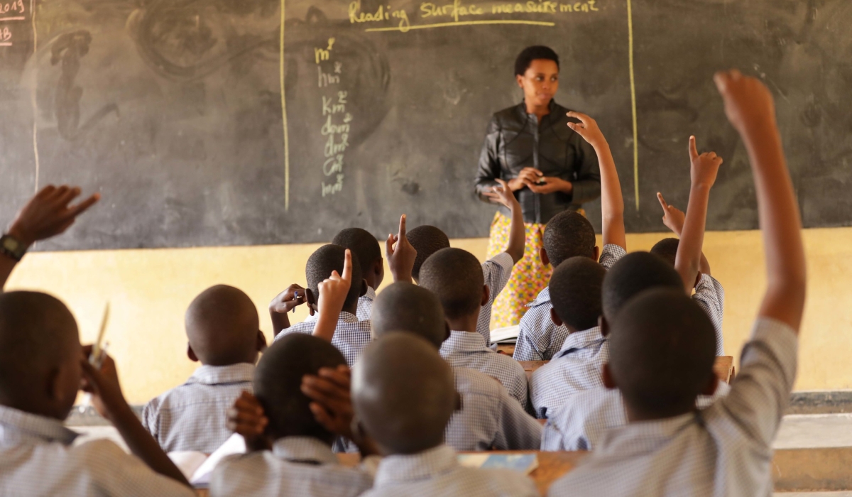 A teacher during a class in a congested classroom. The government needs more than 26,500 new classrooms to reduce overcrowding and phase out double shifts in primary schools. File
