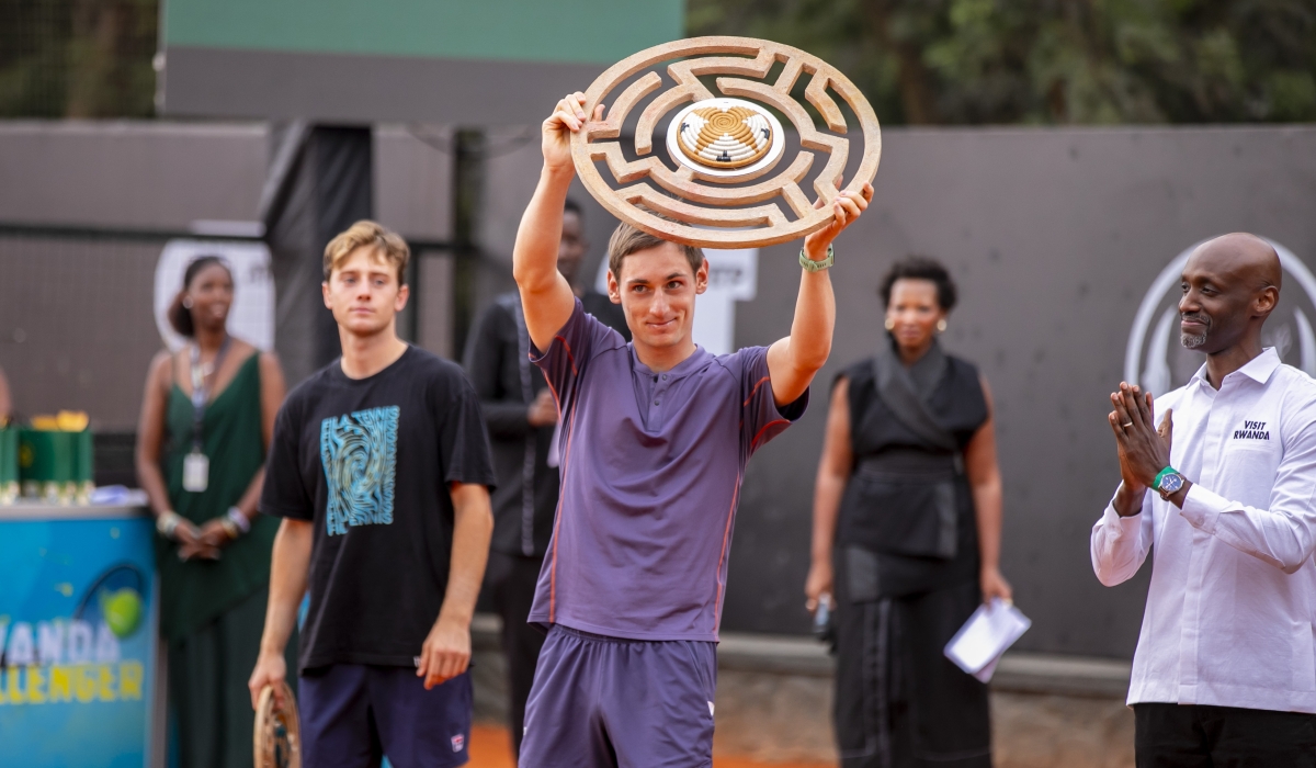 Frenchman Valentin Royer celebrates his Rwanda Challenger 100  trophy before tennis supporters at IPRC-Kigali Ecology Tennis Club after beating Dutch rival Guy Den Ouden 6-2 6-4 in the final on Sunday-courtesy