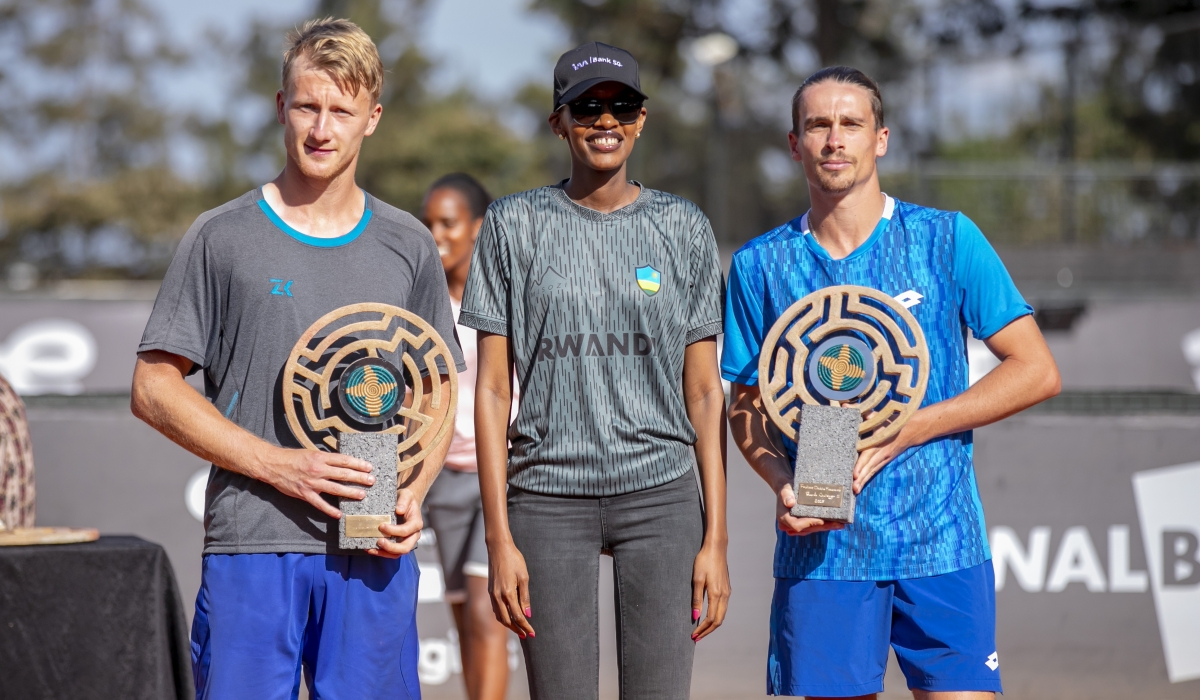 I&M Bank Head of Marketing and Communications, Fiona Kamikazi (c) awards the trophy to Rwanda Challenger 100 doubles winners Siddhant Banthia and Alexander Donski during the awarding ceremony on Saturday, March 9-courtesy
