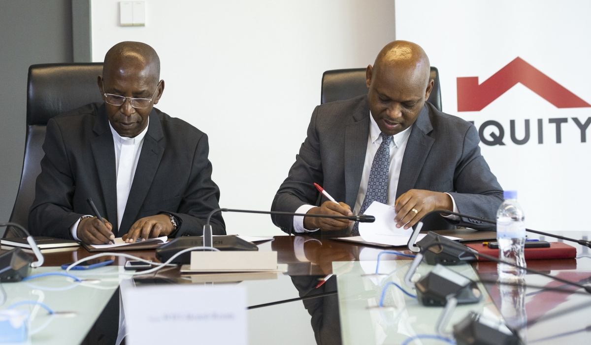 Dr Laurent Ntaganda, Vice Chancellor of the Catholic University of Rwanda and Hannington Namara, Managing Director of Equity Bank sign the agreement in Kigali on March 20. Photos by Keza