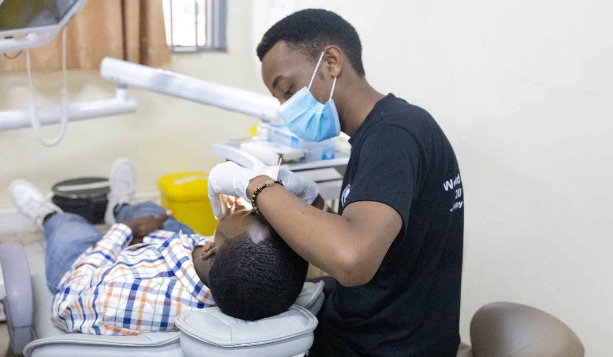 A medic assists a patient during the celebration of World Oral Health Day in Kigali on Thursday, March 20. Courtesy