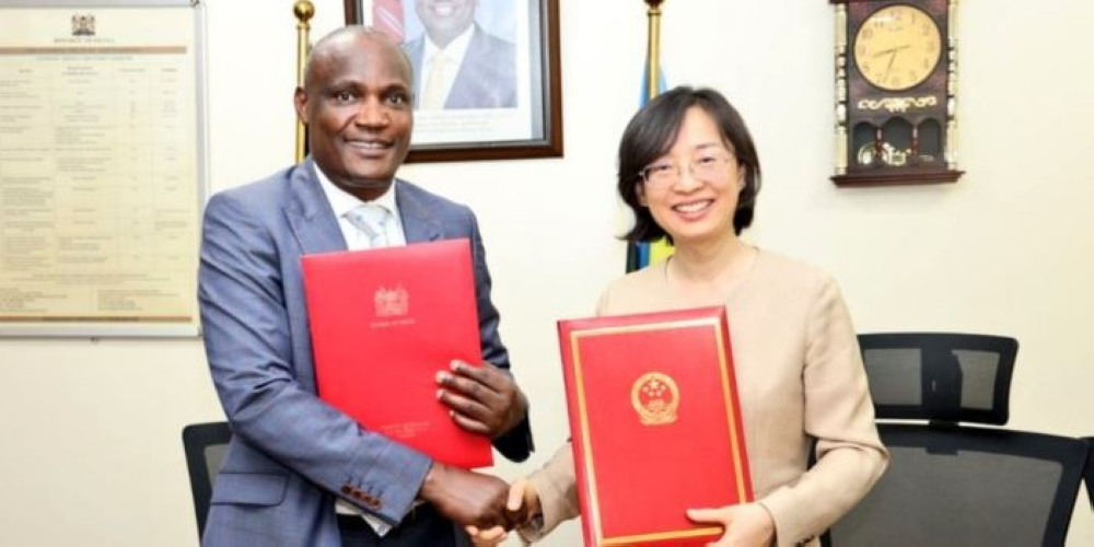 Kenya&#039;s Treasury Cabinet Secretary John Mbadi shakes hands with the Chinese Ambassador to Kenya, Guo Haiyan, after signing the grant agreement on March 27. Courtesy