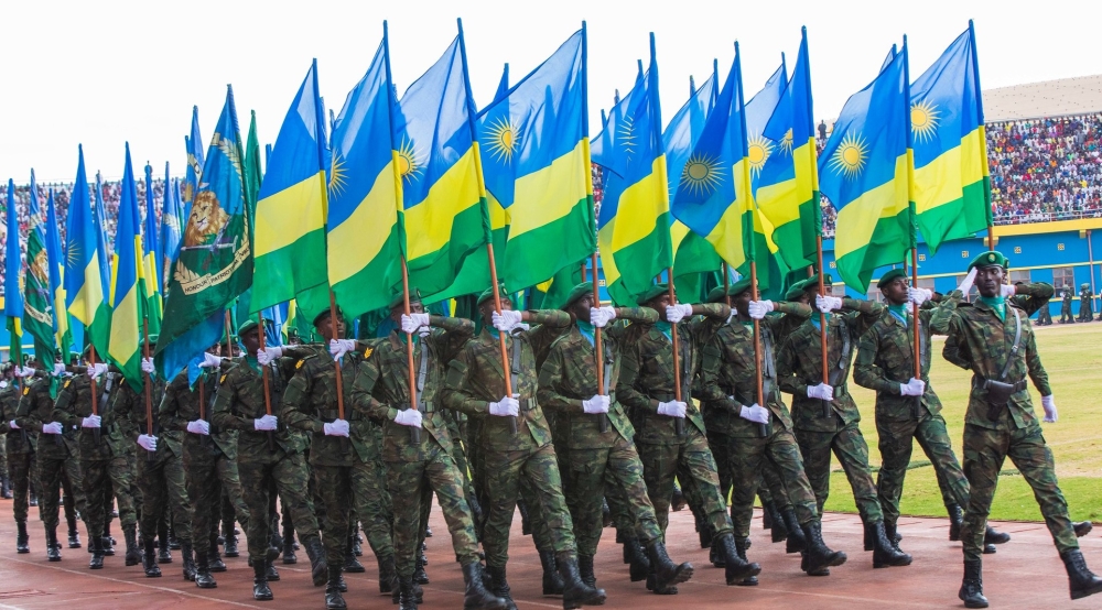 Rwanda Defence Force officers with national flags during a military parade. PHOTO BY SAM NGENDA