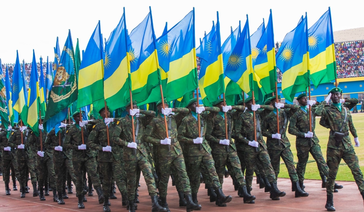 Rwanda Defence Force officers with national flags during a military parade. PHOTO BY SAM NGENDA