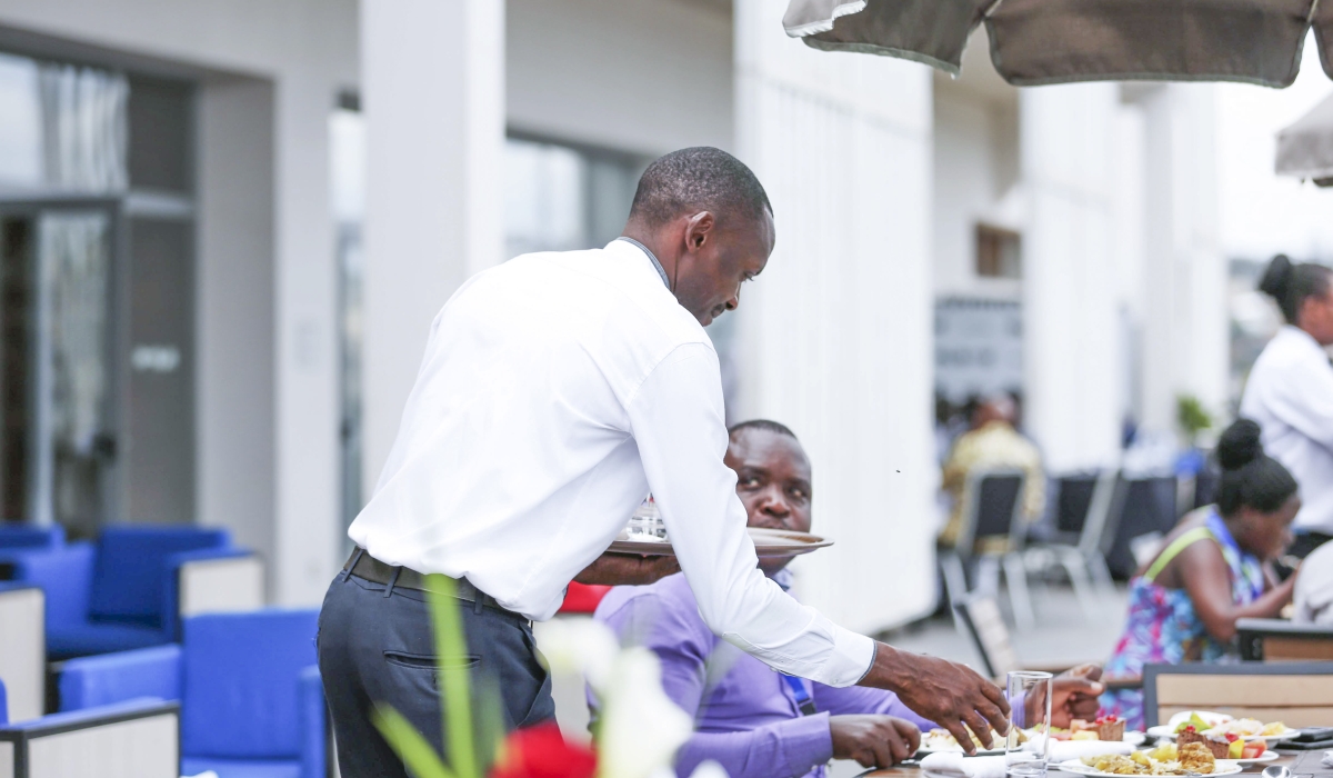 A waiter serves a customer at a hotel in Kigali. The services sector had the majority of the employed population in 2024, according to the Labour Force Survey 2024. Photo by  Sam Ngendahimana