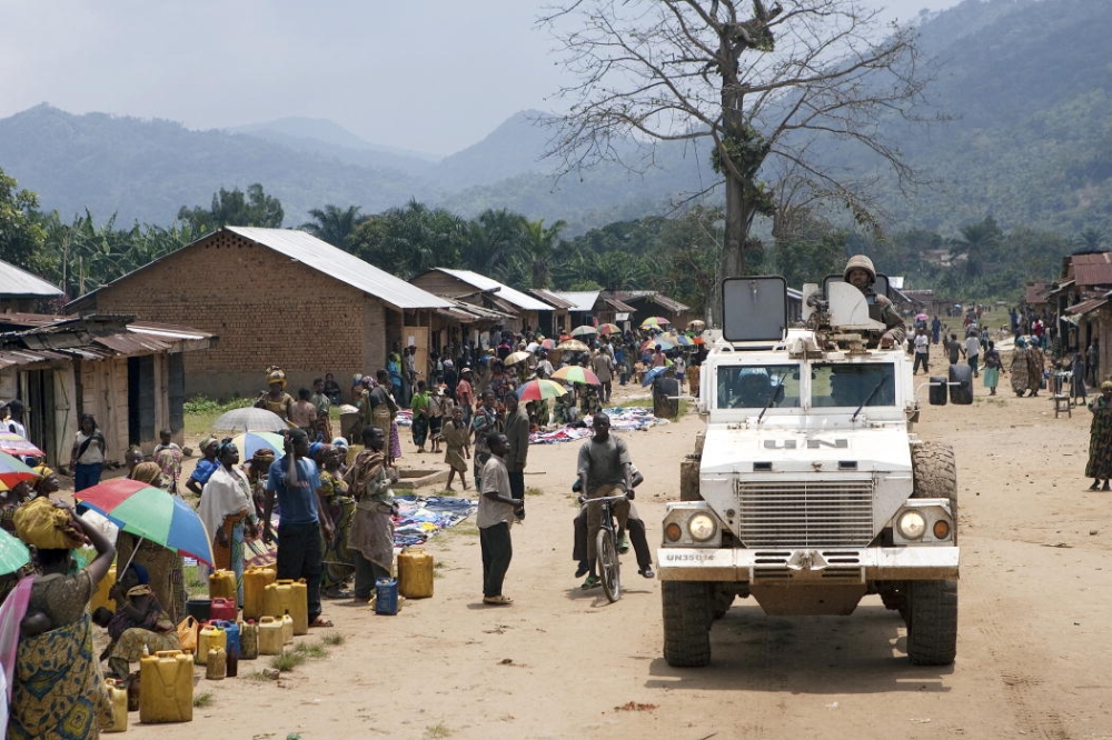 An armored vehicle operated by the members of the South African battalion, transports  Alan Doss, Special Representative of the Secretary-General and Head of the United Nations Organization Mission in the Democratic Republic of the Congo (MONUC) and his delegation, through a village street to their Helicopter Operating Base after visiting a camp of the Internally Displaced Persons (IDPs) in Pinga.   21/Feb/2009. UN Photo/Marie Frechon. www.unmultimedia.org/photo/