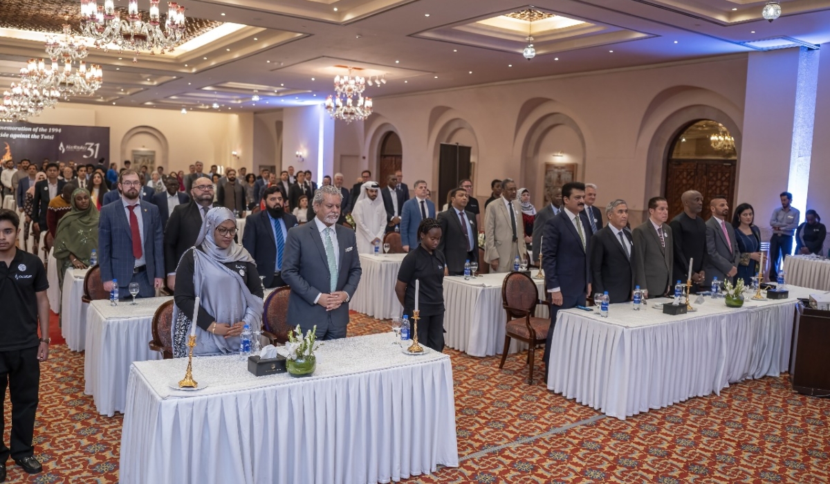 Mourners observe a moment of silence to honour victims of the genocide