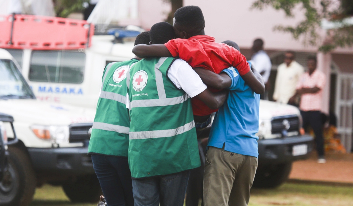 Red Cross volunteers help a trauma victim at  Nyanza-Kicukiro Genocide Memorial. Photo by Sam Ngendahimana