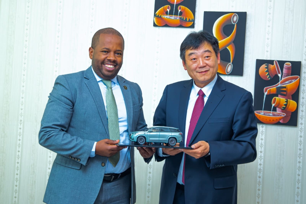 Kigali City Mayor Samuel Dusengiyumva and Chery Holding Group Chairperson Xu Hui pose for a photo after discussions with a delegation from the Chinese automotive company. Courtesy Photo