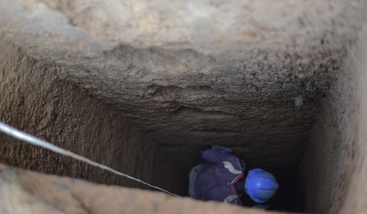 A resident exhuming the bodies of the victims from a mass grave. Today, on April 19, 1994, Tutsi in Kamonyi were forced to dig their own graves, Sindikubwabo mobilises the public to kill. FILE