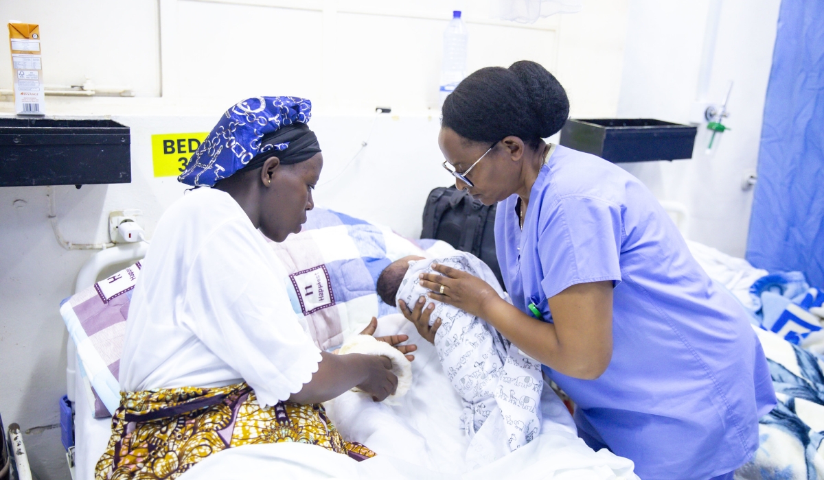 A midwife helps a mother after the birth of her newborn in Kigali. Photo by Emmanuel Dushimimana