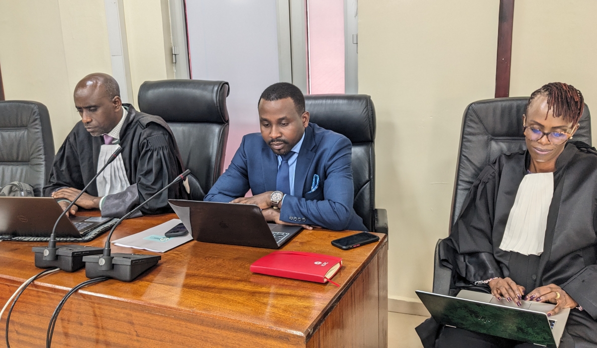 Lawyer Jean Paul Ibambe (centre) flanked with his defence team at the Supreme Court before the hearing began on Monday, May 5. Photo by Hudson Kuteesa 