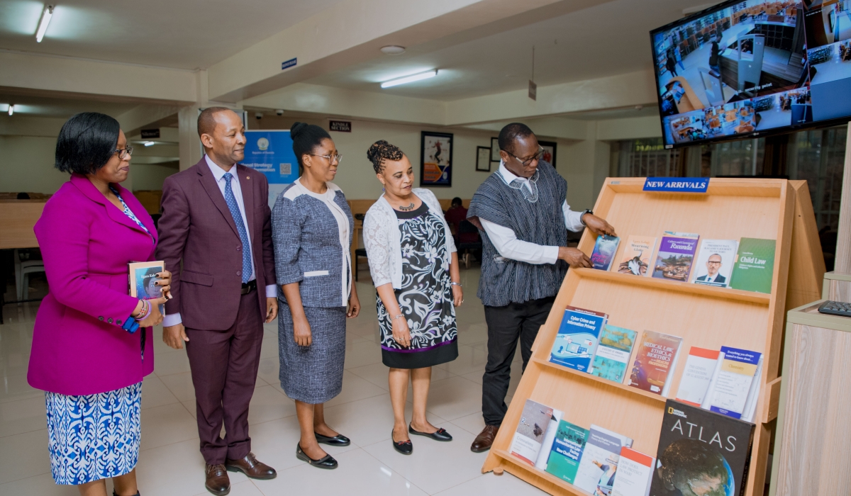 Prof Egara Kabaji places the book he donated to the university&#039;s collection. Looking on from left to right are Muthee Lucy Wangechi, Dr Martin Kimemia, Dr Eugenia Nkechi Irechukwu, and Dr Ruth Thinguri.