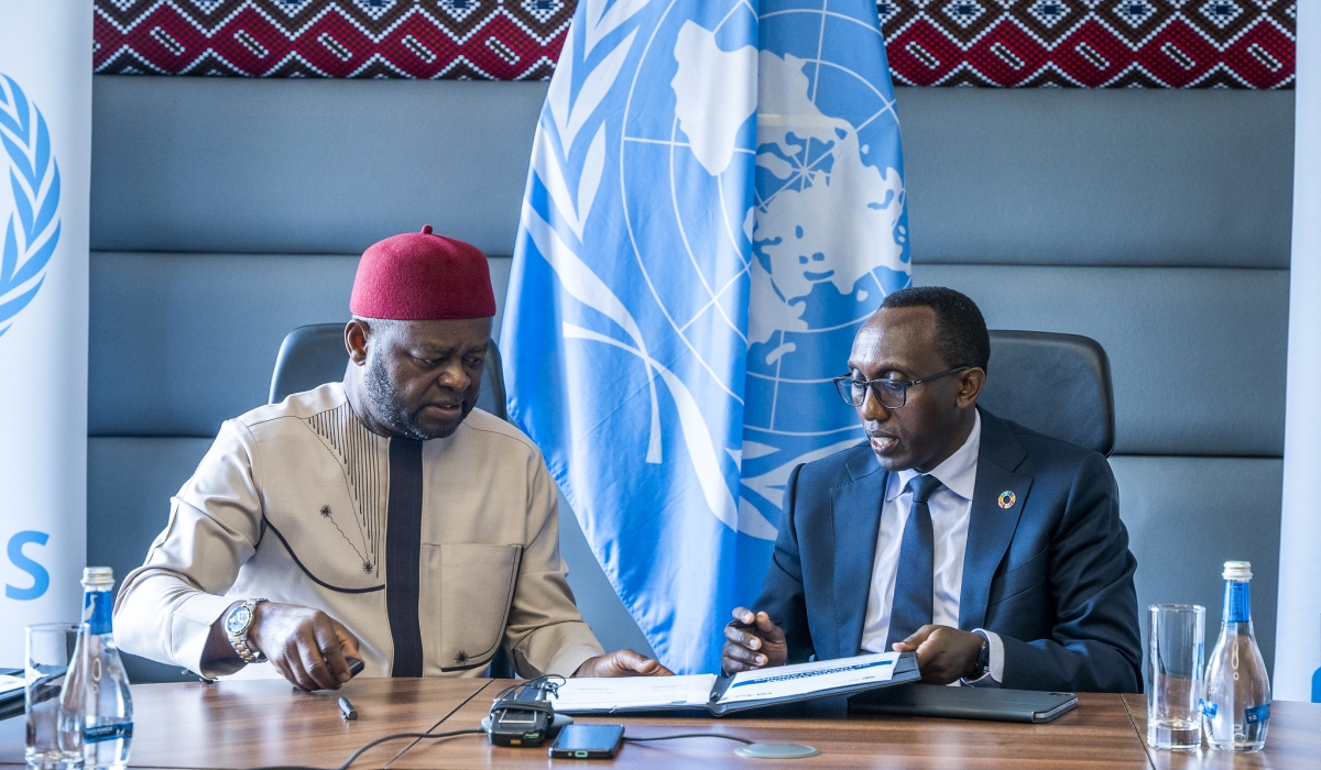 Ozonnia Ojielo, the UN Resident Coordinator in Rwanda and Benjamin Mutimura, CEO of I&M Bank Rwanda  sign the agreement on Friday, May 23. All photos by Craish Bahizi.