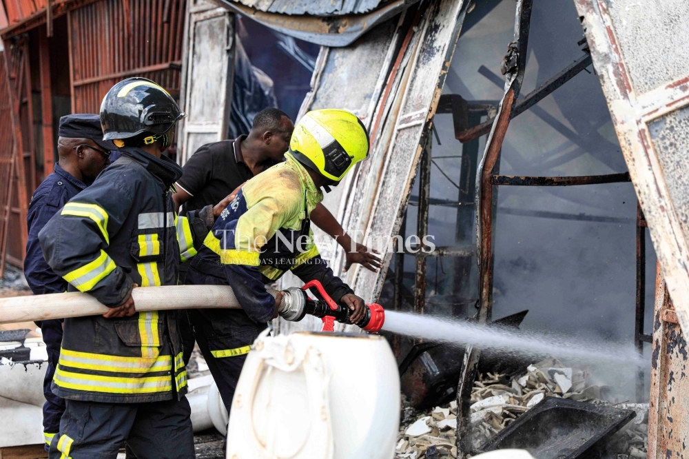 Firefighters extinguish a blaze that affected the Gisozi-based carpentry workshops on May 30. Photo by Kellya Keza