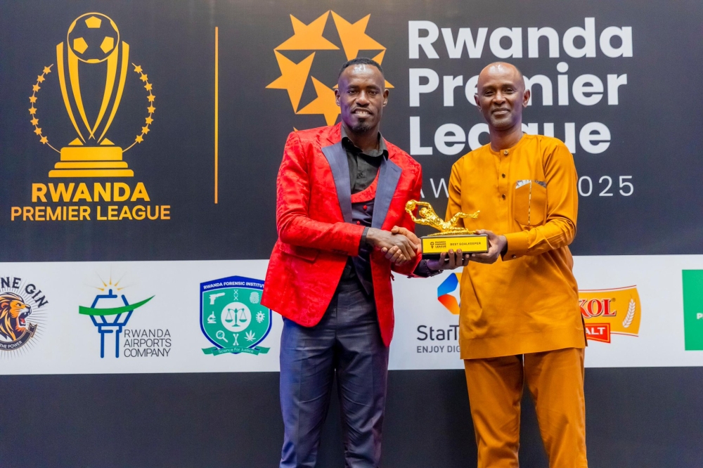 Mukura VS skipper Nicolas Sebwato(L) receives his best goalkeeper of the year award from Rwandan goalkeeper Eugene Eric Murangwa-courtesy