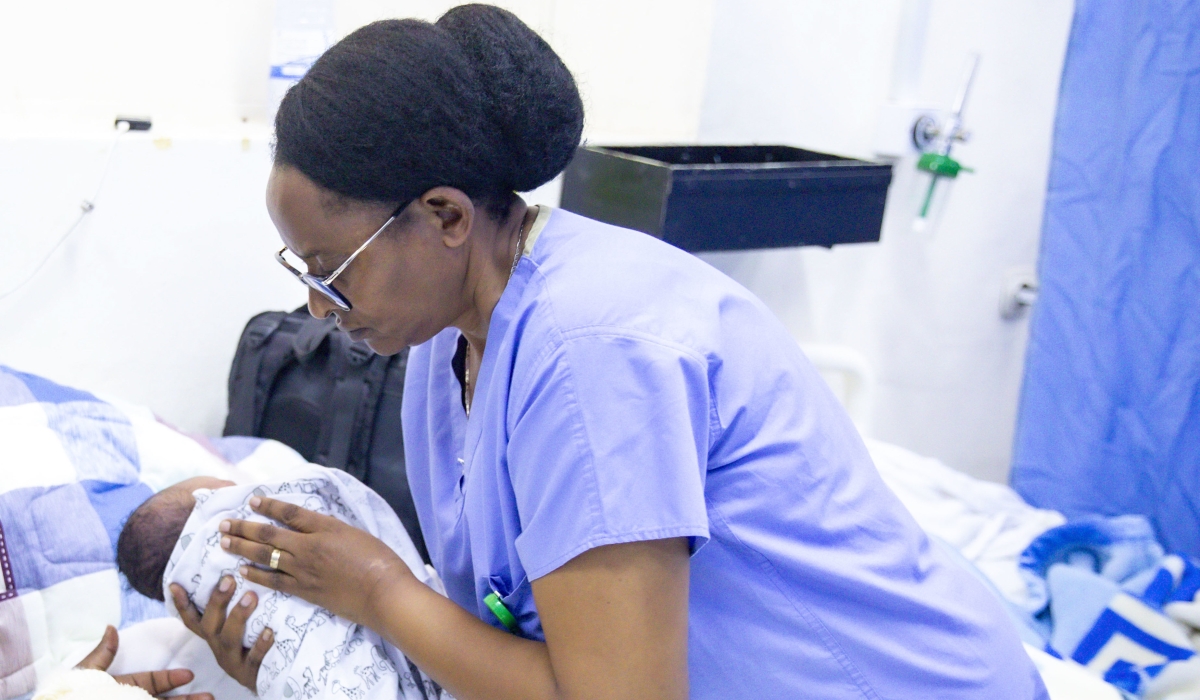 A nurse holds a newborn at Kigali-based hospital on January 1. Photo by Emmanuel Dushimimana