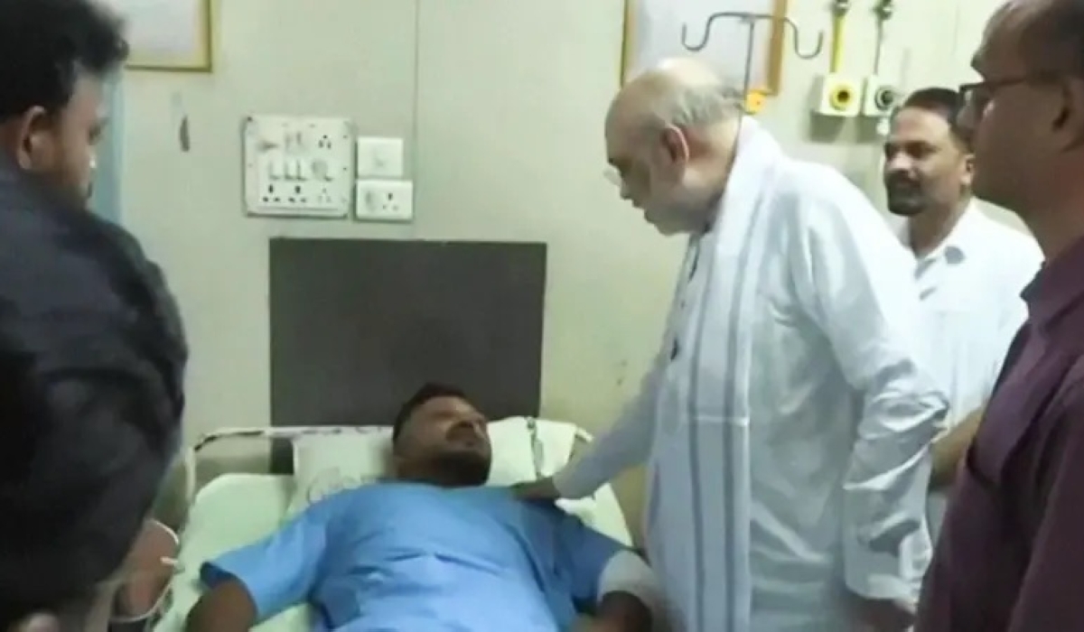 Vishwashkumar Ramesh meets Indian interior minister Amit Shah in hospital. PHOTO: REUTERS