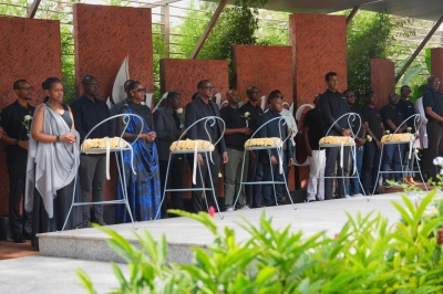 Ministers and other officials observe a moment of silence during the event.