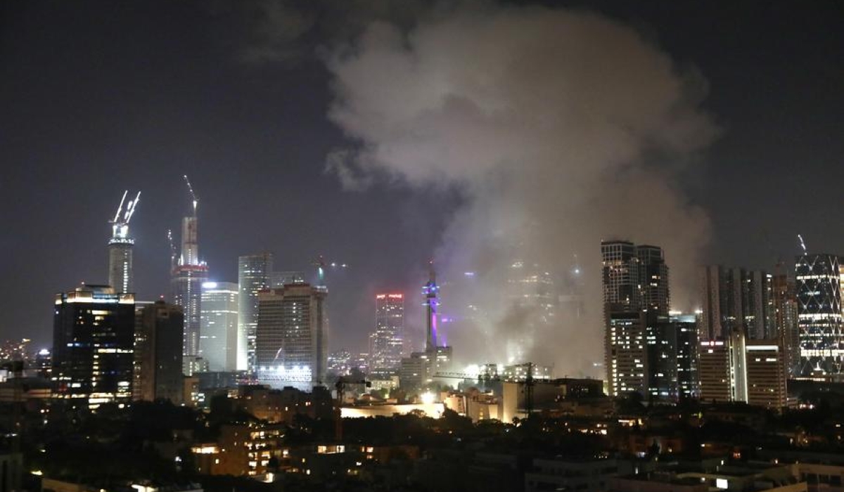 Smoke rises following an Iranian missile attack in Tel Aviv, Israel, on June 13, 2025. Dozens of missiles were fired from Iran into Israel on Friday evening, according to statements issued by the Israel Defense Forces (IDF). (Gideon Markowicz/JINI via Xinhua)