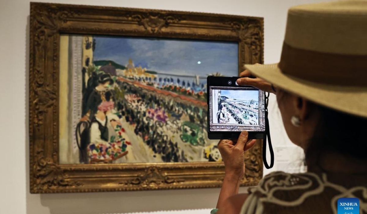 A woman takes photos of a painting at an exhibition with the theme related to the ocean at the Henri Matisse Museum in Nice, southern France, June 12, 2025. (Xinhua/Gao Jing)