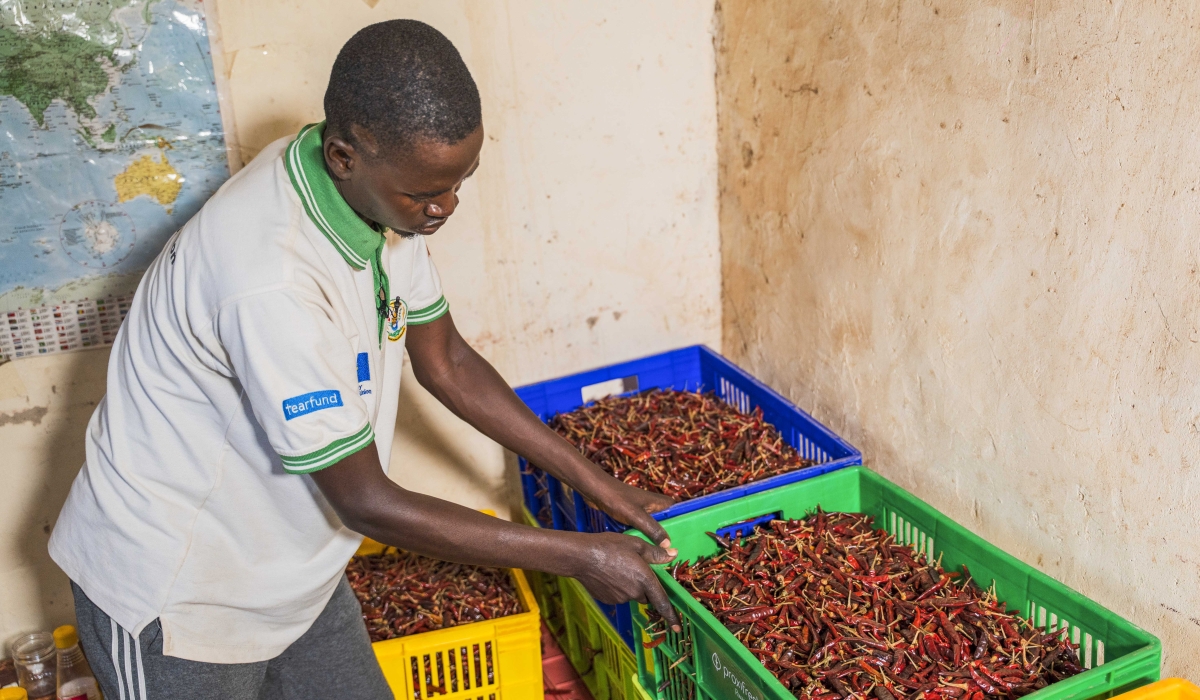 A member of cooperative that grows chili, works in a post-haverst store in Gasabo District. Courtesy