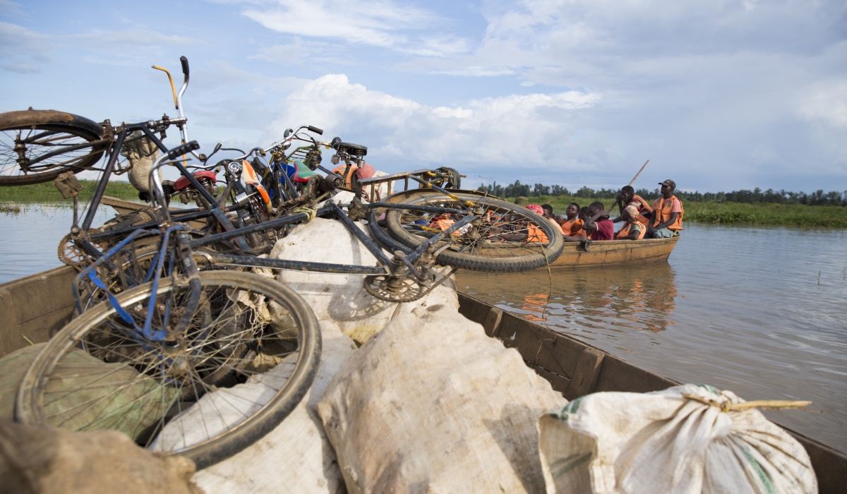 Sharita residents cross Nyagisenyi stream on their way back home from market in Rweru Sector. Over 80 families remaining to the island call for  relocation. Photos by Sam Ngendahimana