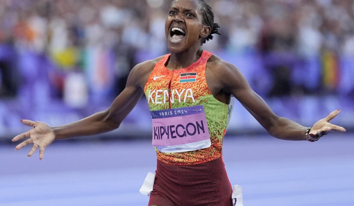 Faith Kipyegon, of Kenya, celebrates winning the women's 1500-meter final at the 2024 Summer Olympics, Saturday, Aug. 10, 2024, in Saint-Denis, France. (AP Photo/Matthias Schrader)